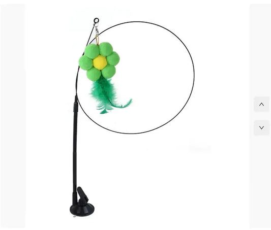 Green flower-shaped cat toy with feathers, hanging from suction-cup wand