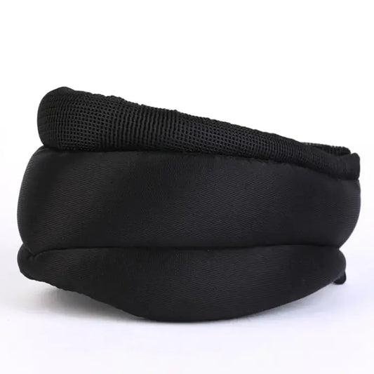 Black padded eye mask with mesh lining, soft sleep accessory on white background